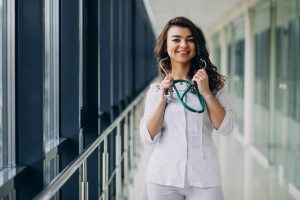 young woman doctor with stethoscope hospital